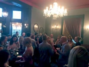 The crowd gathers in the main room for cocktails and appetizers.