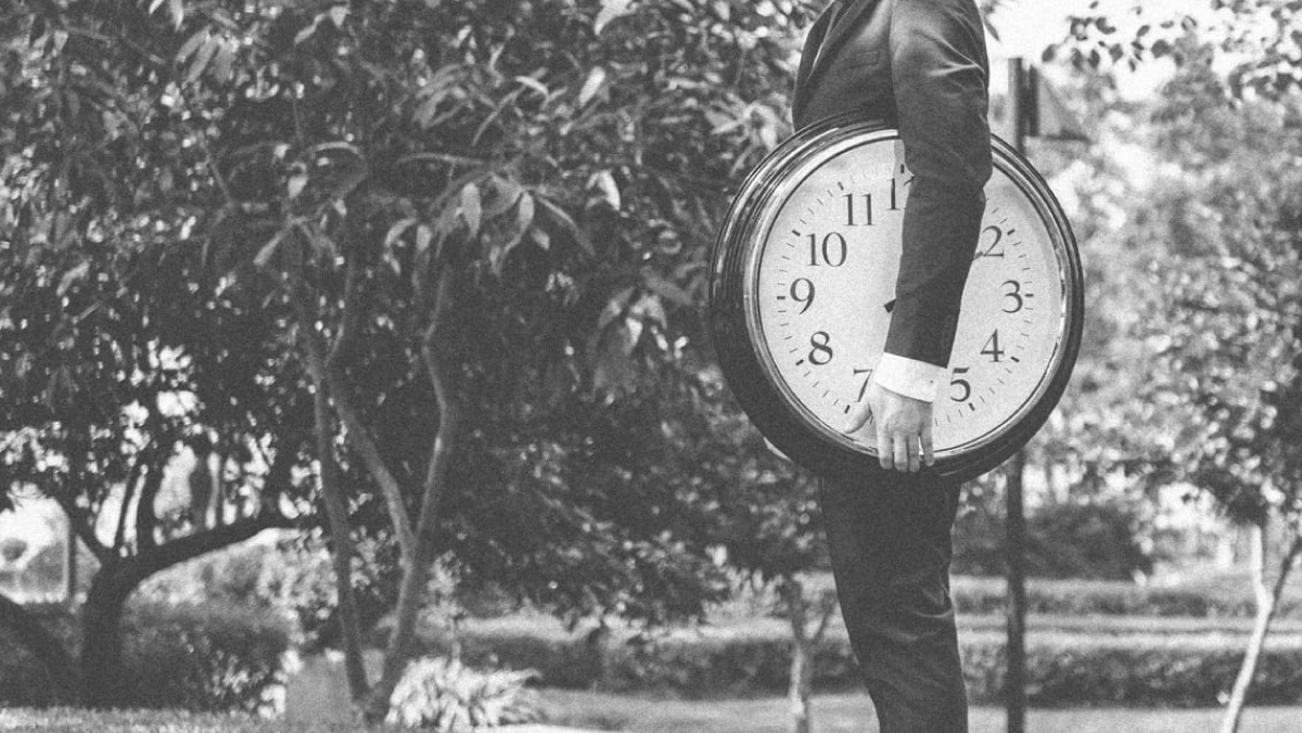 Person Holding Clock