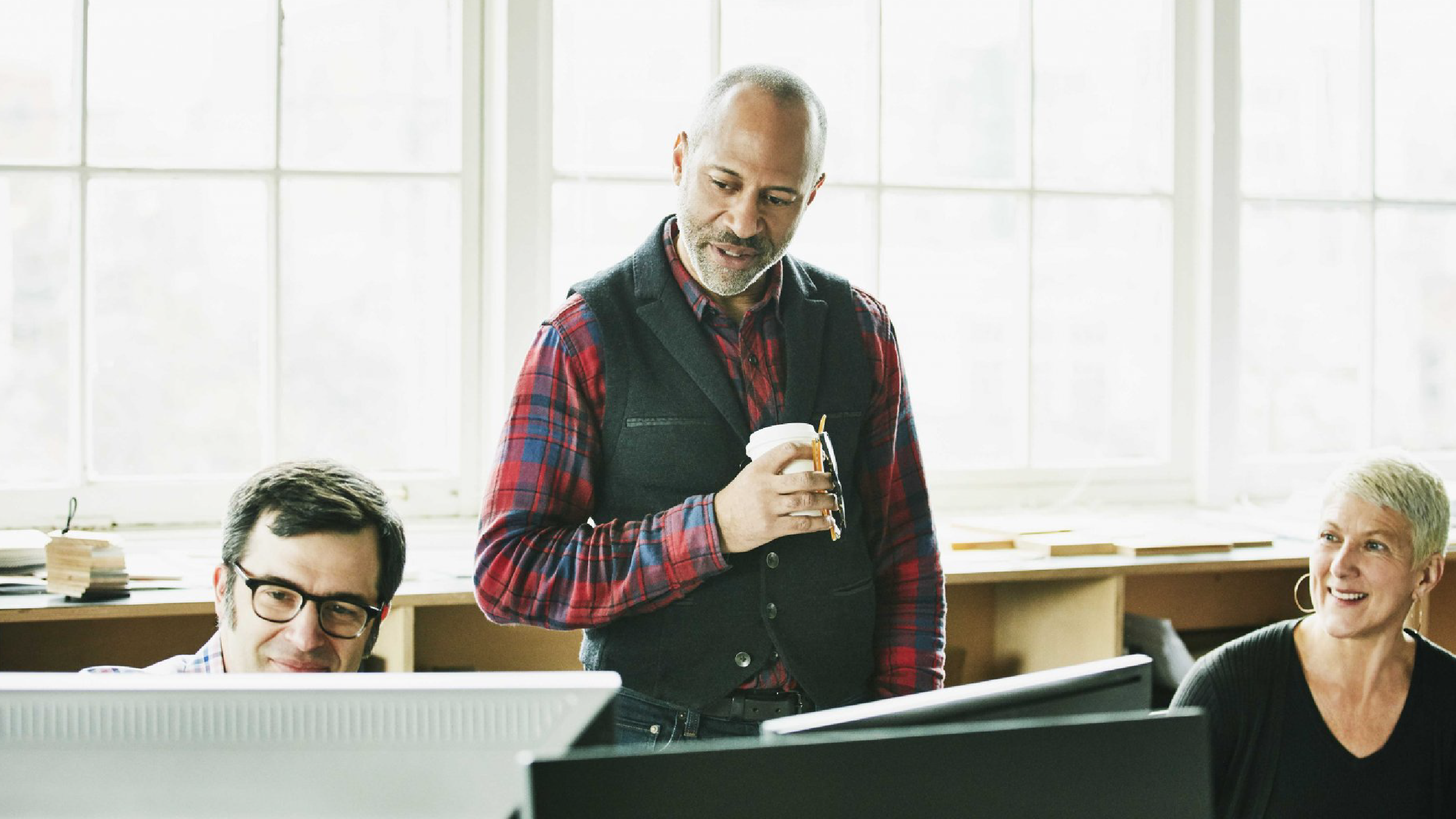 Team members looking at computers